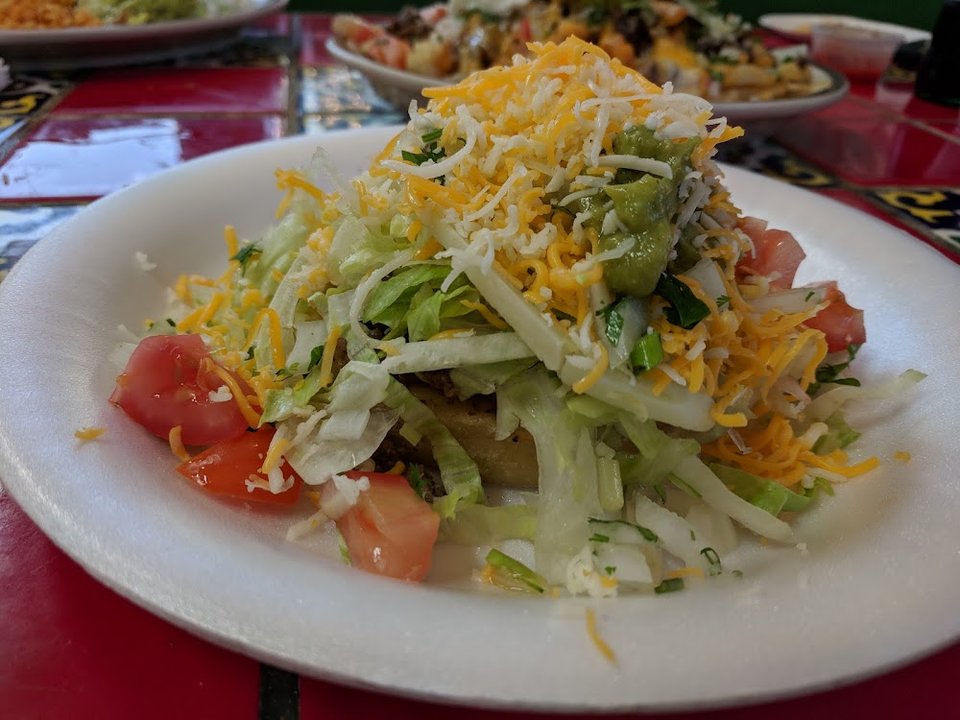 Printed menu with tacos and enchiladas.